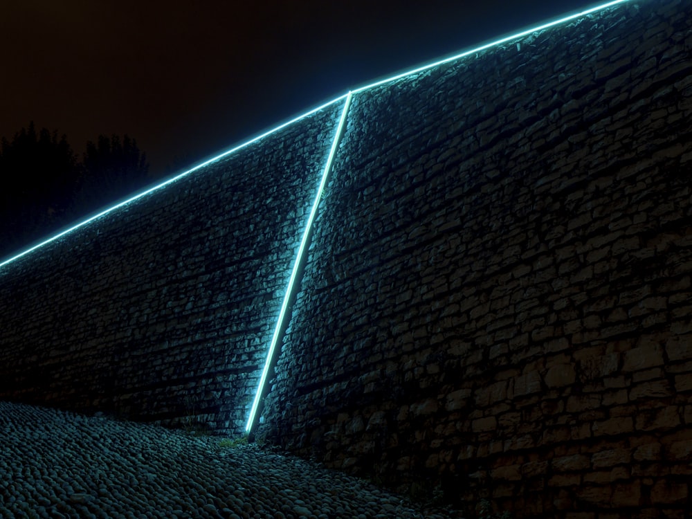a stone wall with a light shining on it