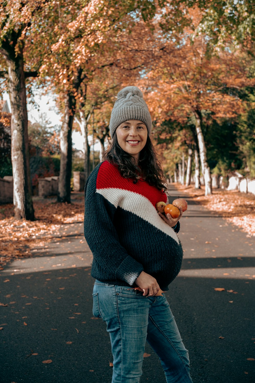 a person wearing a hat and holding a fruit