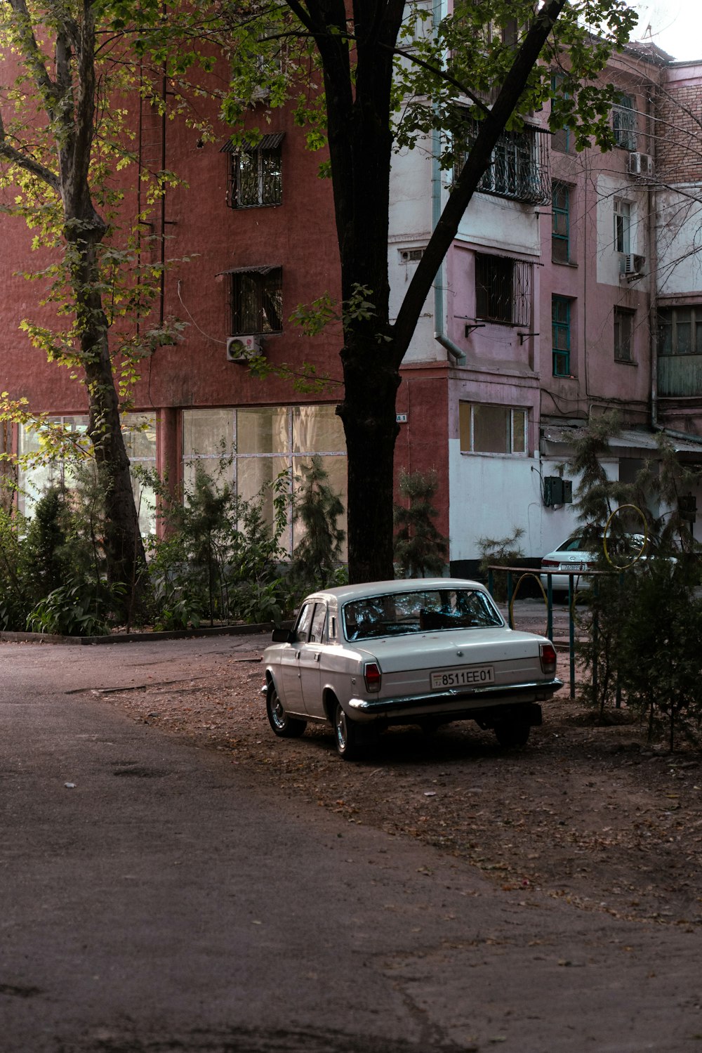 a white car parked in front of a building