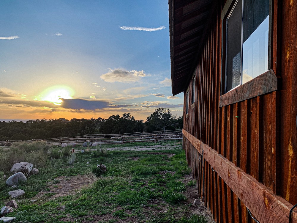 a barn with a sunset in the background