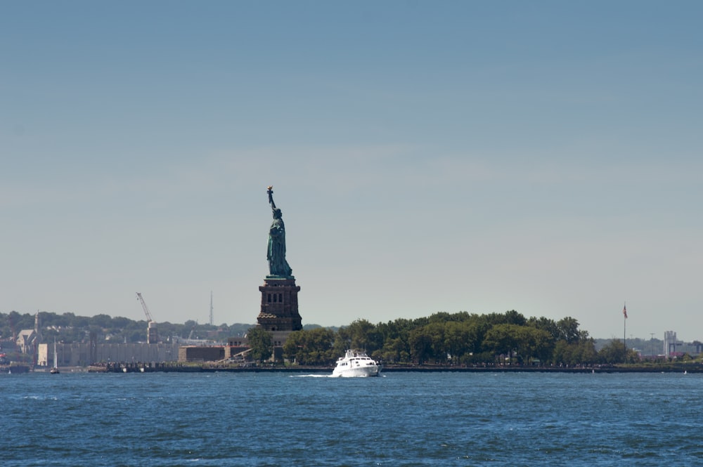 a large statue next to a body of water