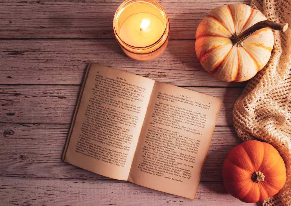 a book and a couple pumpkins