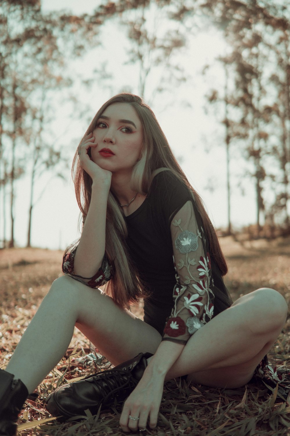 a woman sitting on the ground