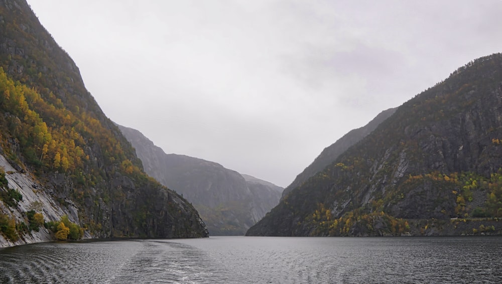 a body of water with mountains in the back