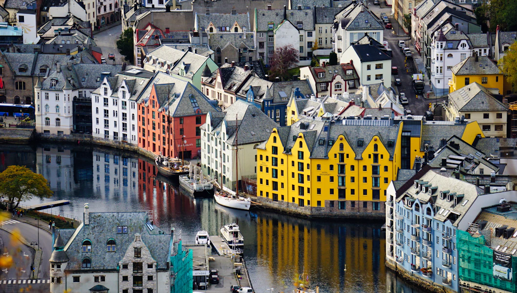 Colorful Ålesund buildings and boats along the waterfront on a calm day