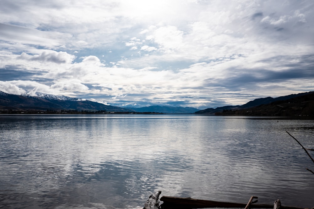 a body of water with mountains in the background