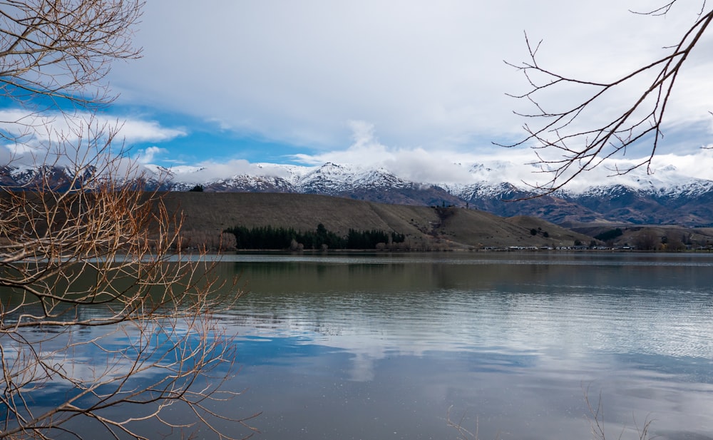 a lake with mountains in the background