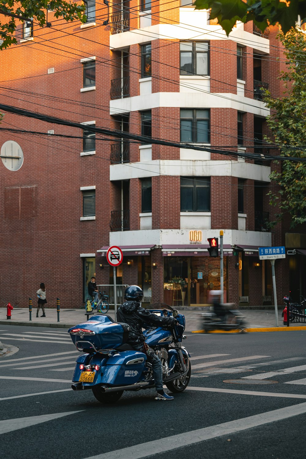 a person riding a motorcycle down the street