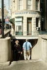 a man and a woman walking down a sidewalk