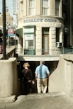 a man and a woman walking down a sidewalk