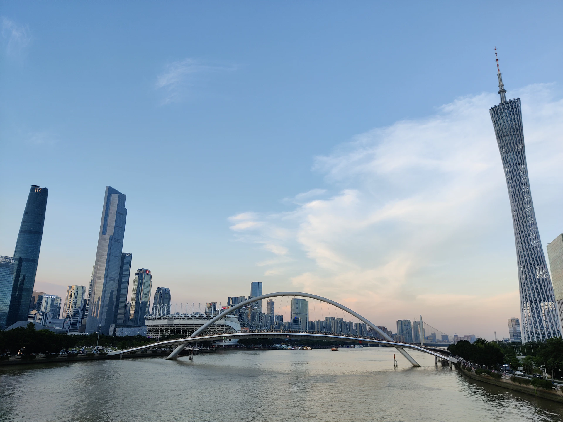 a bridge over a river with a city in the background