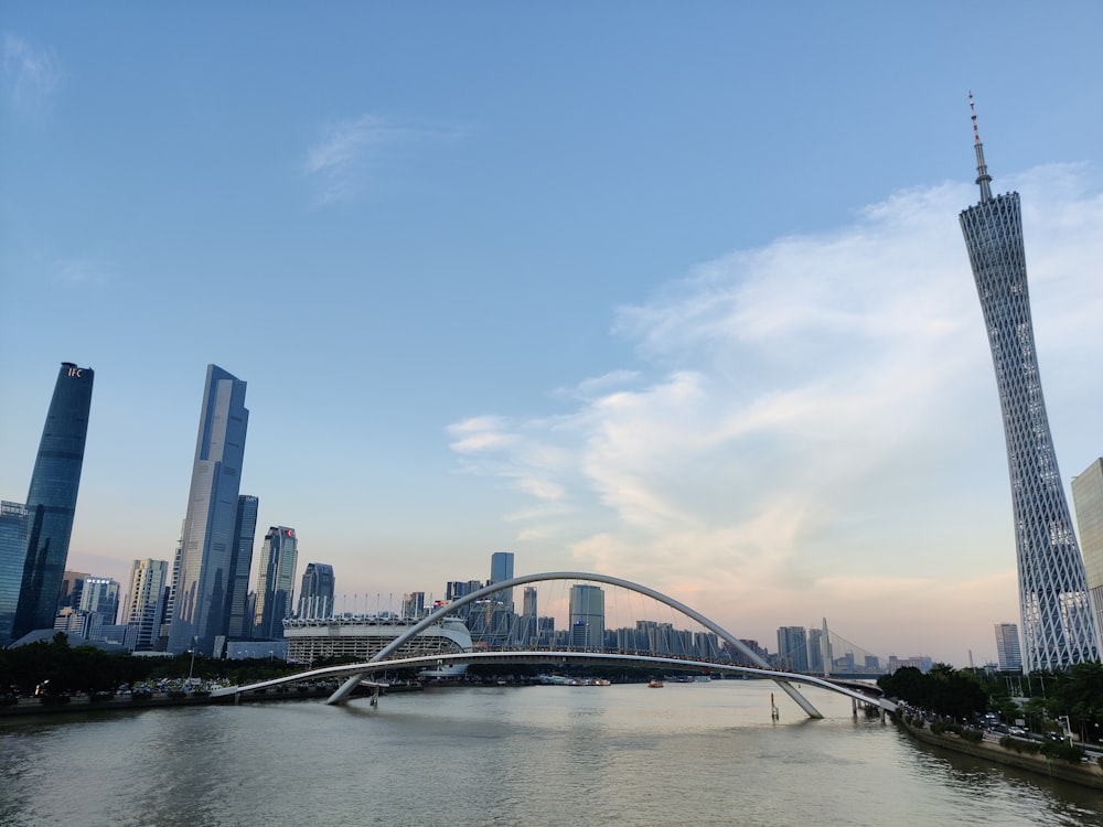 a bridge over a river with a city in the background