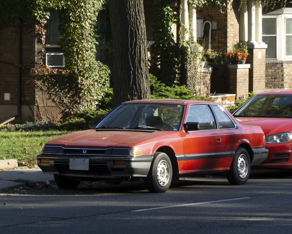 a red car parked on the side of a road