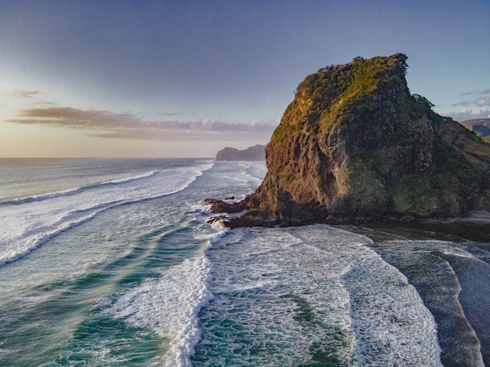 a rocky cliff next to the ocean