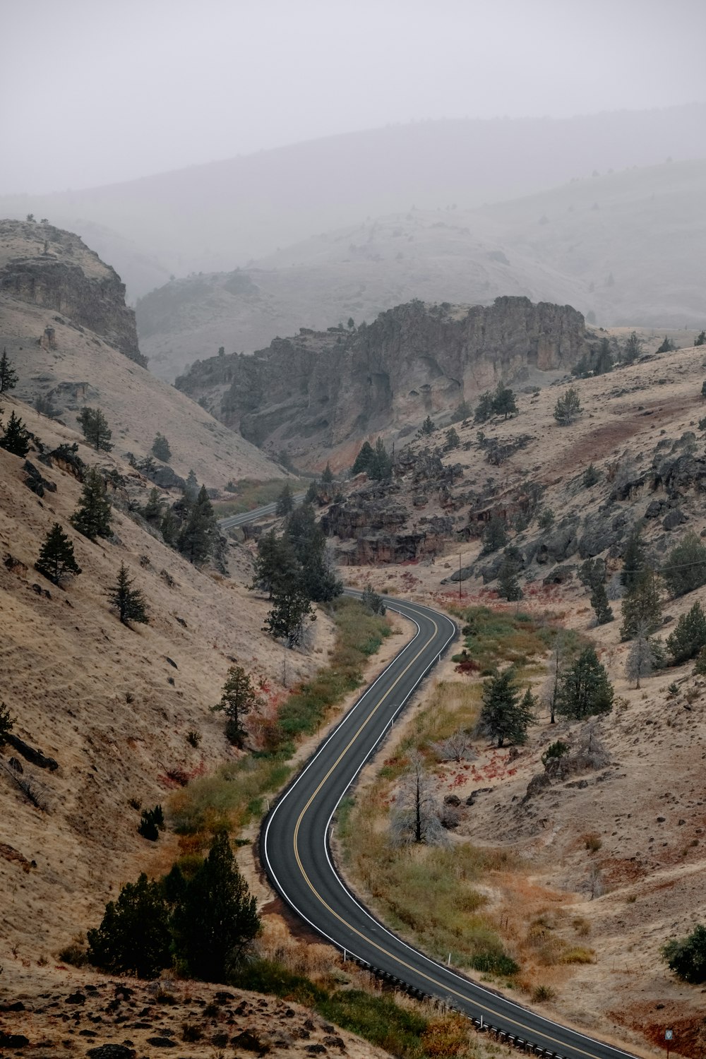 a winding road through a valley