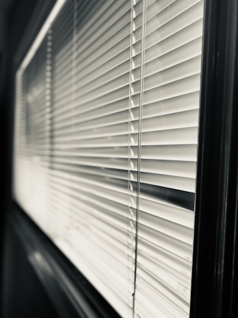 Close-up image of a stylish, high-quality window blind installed in a bright room.