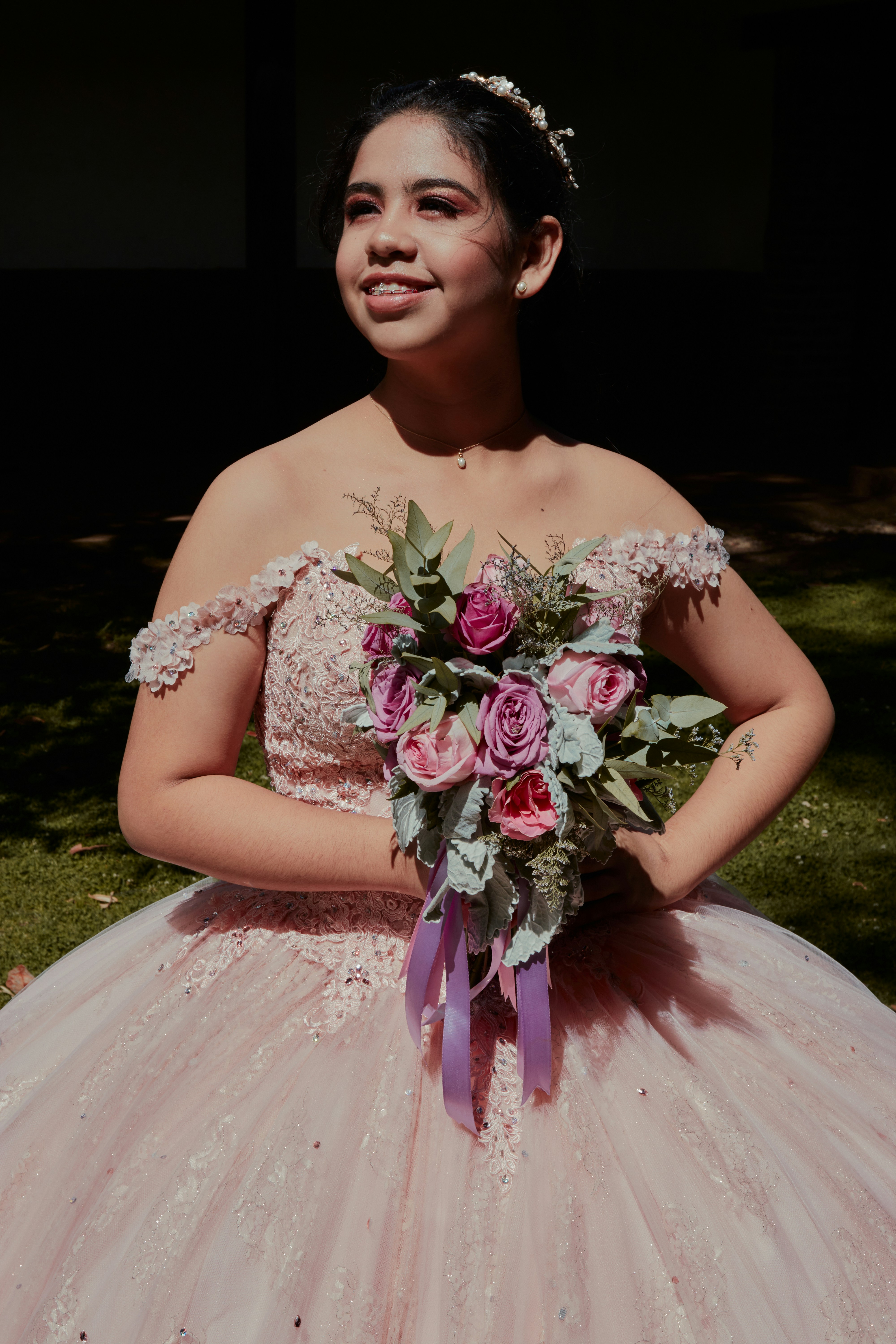 a woman in a dress holding a bouquet of flowers