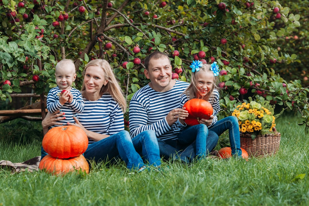 a man and a woman sitting on a bench with a pumpkin and a pumpkin