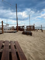 Relaxed outdoor patio with string lights, comfortable seating, and ocean breeze vibes.