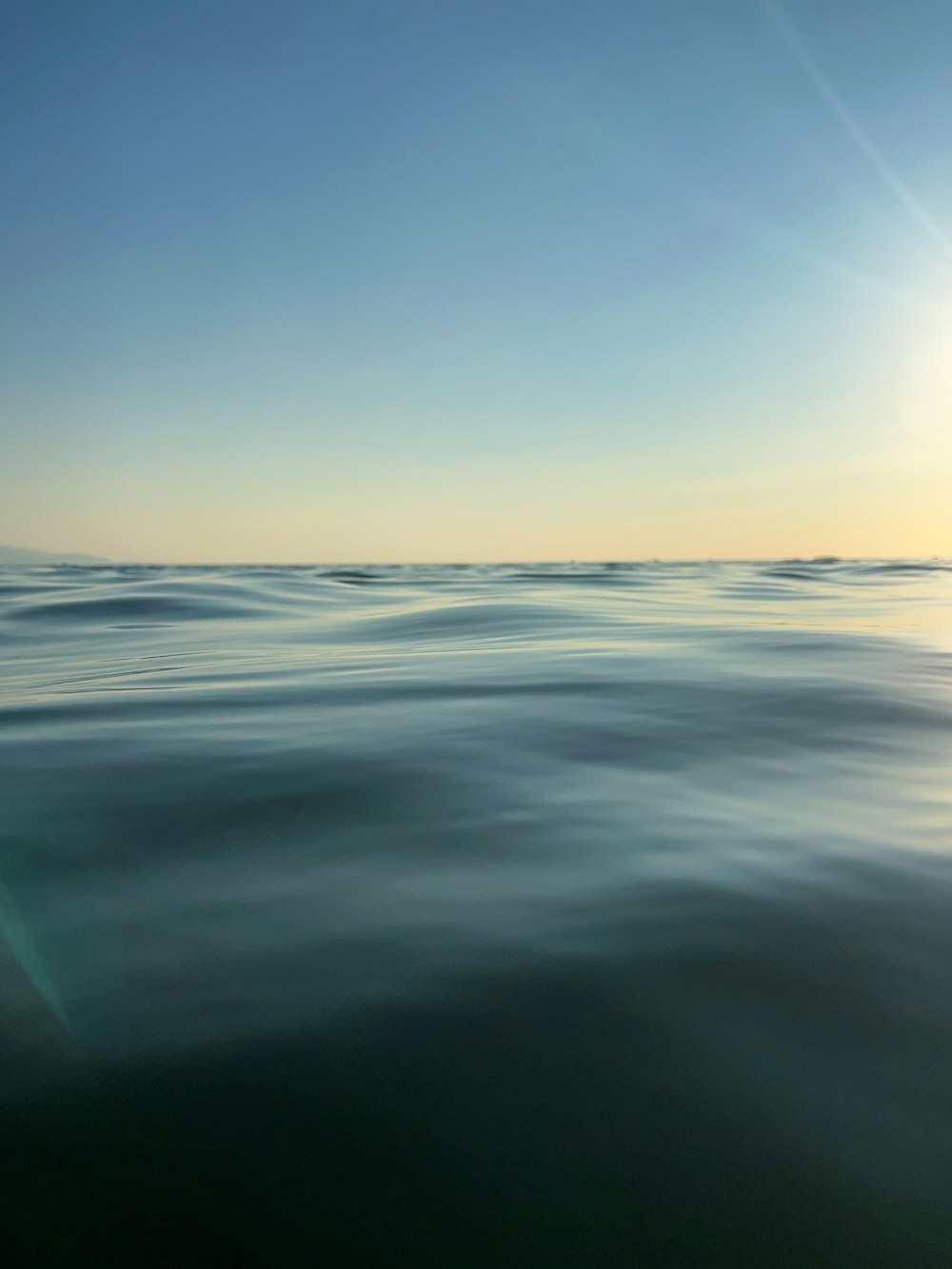 a body of water with clouds above