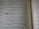 A close-up view of an open book displaying text in two columns. The text appears to be religious or philosophical in nature, with verses numbered and formatted in a poetic structure.