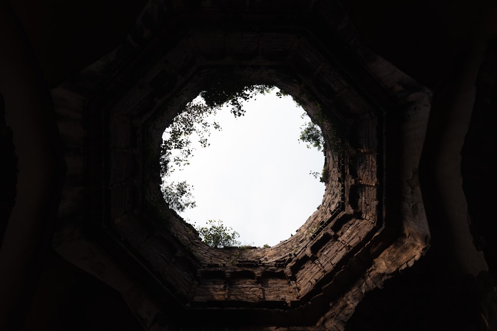 a stone archway with trees in the background