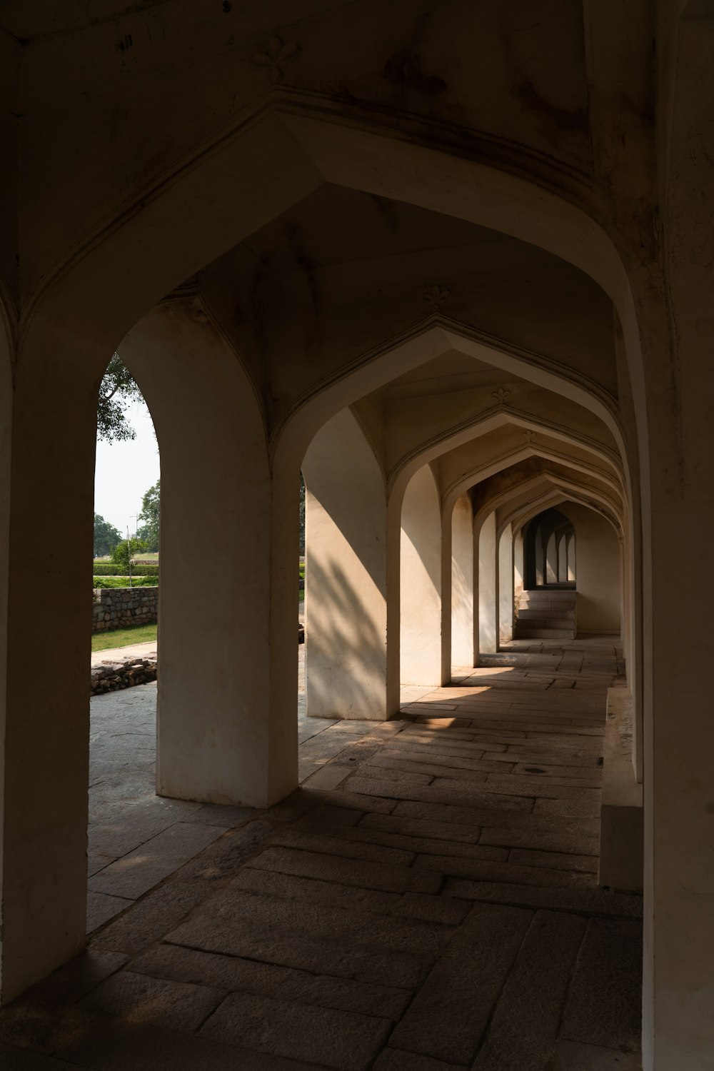 a stone walkway with pillars