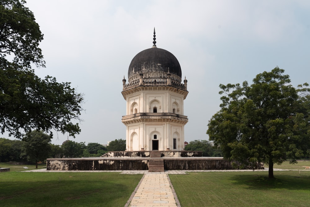 a white building with a dome and a tower