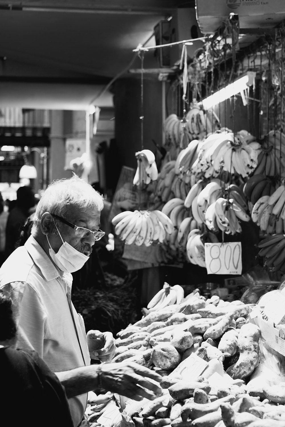 a person selling bananas at a market