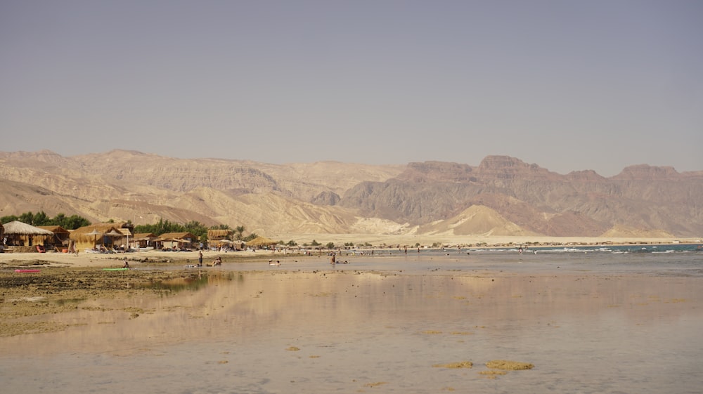 a body of water with buildings and hills in the background