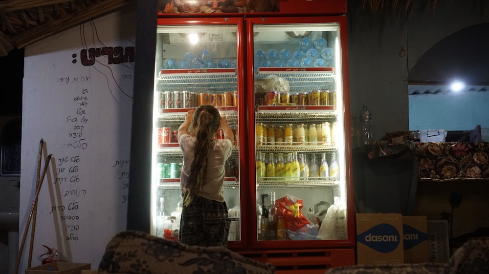 a person standing next to a refrigerator