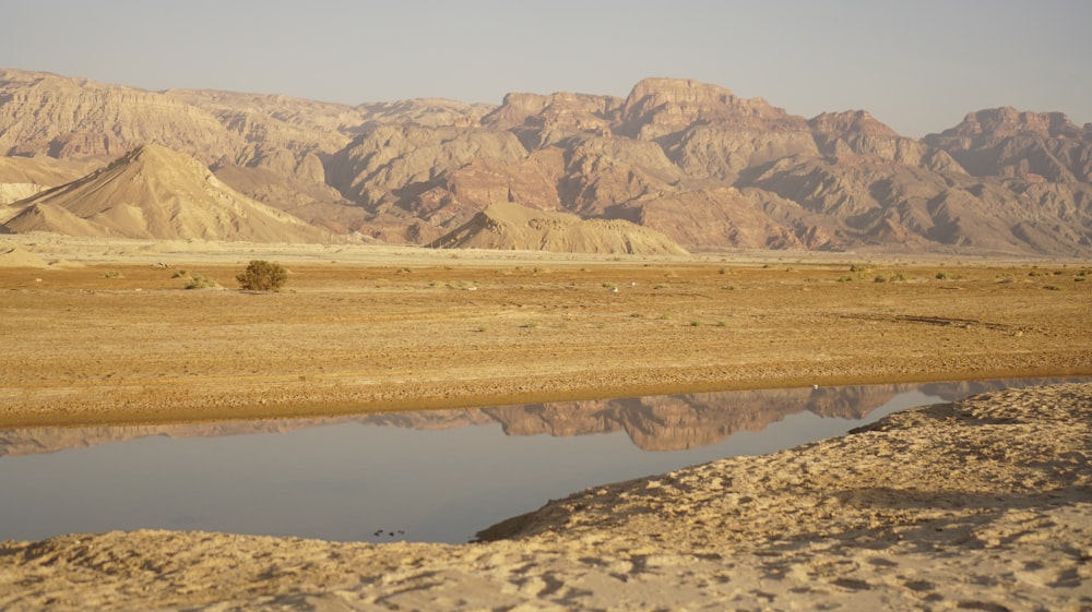 a body of water with hills in the background