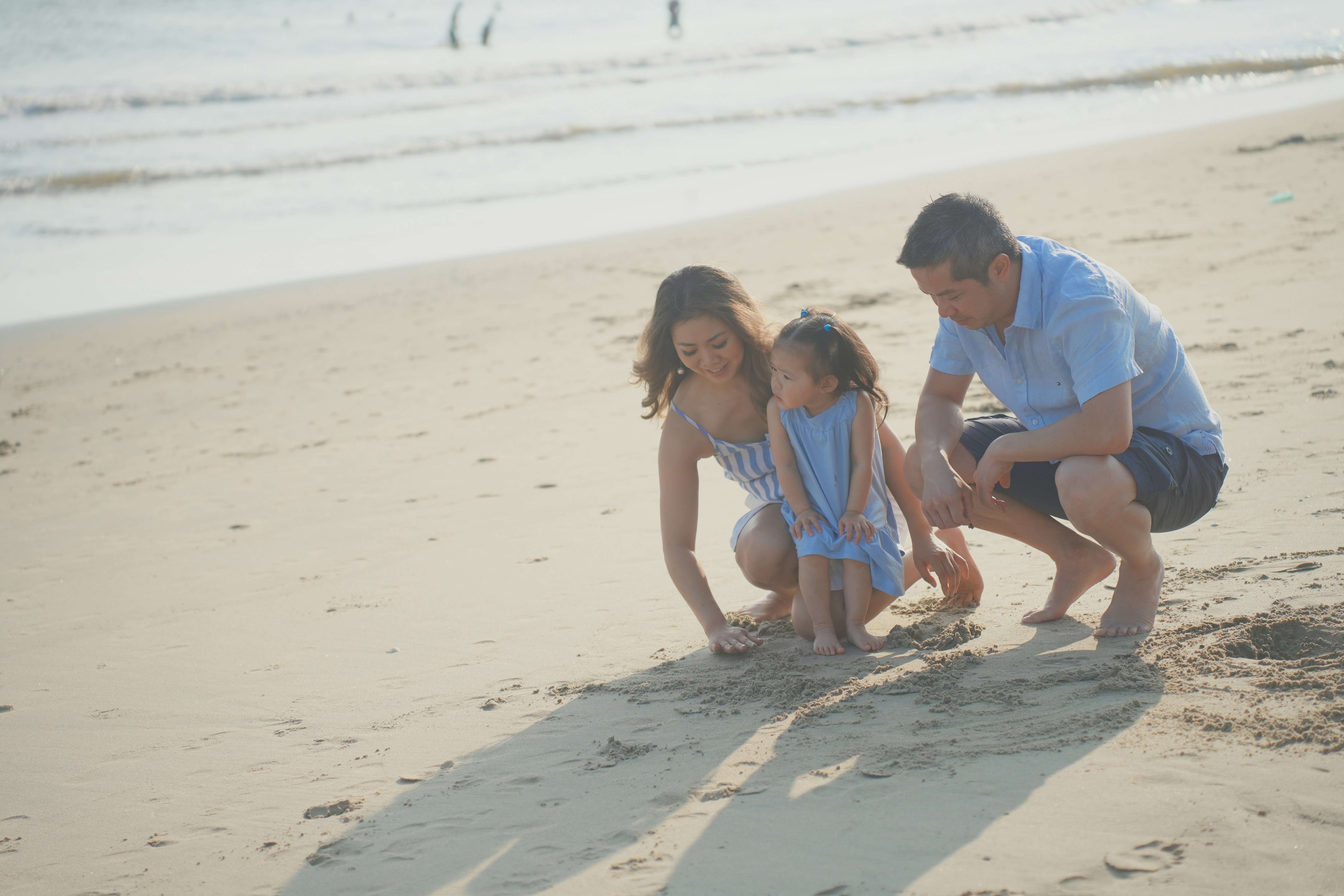 Family taking a break at the Black Sand Beach during their Hana road trip
