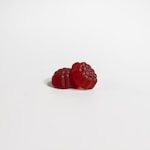 a red raspberry on a white background