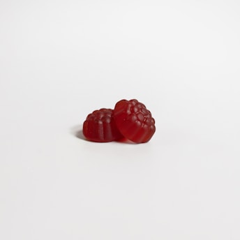 a red raspberry on a white background
