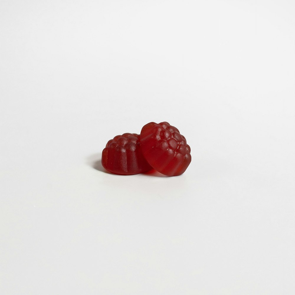 a red raspberry on a white background