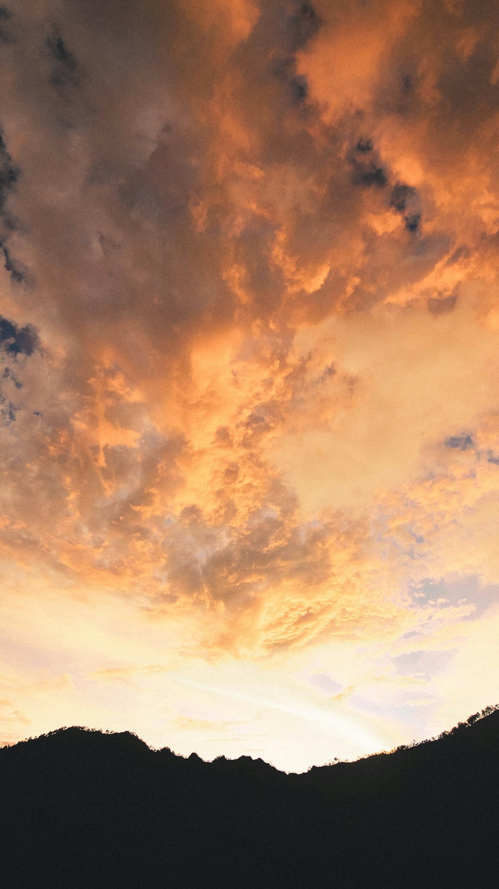 a sunset over a mountain