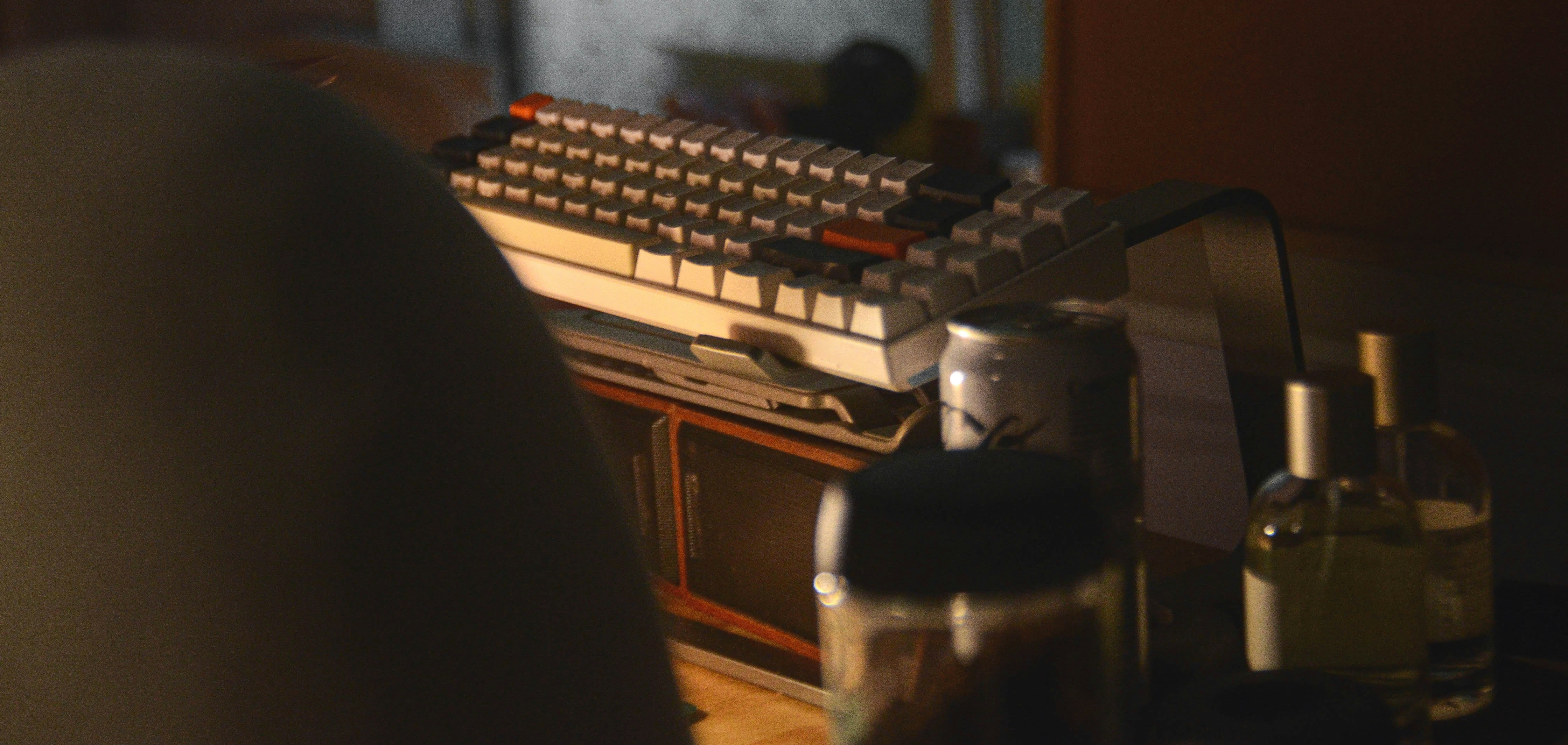 A silhouette of a journalist writing on a typewriter, with news headlines scrolling in the background, symbolizing press freedom.