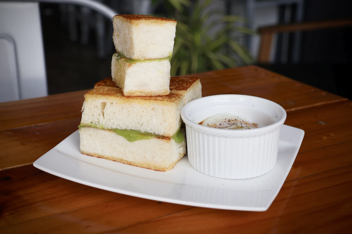 Toast with kaya and butter beside a cup of coffee