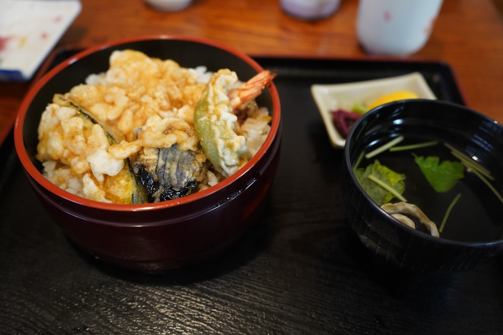 a bowl of food next to a bowl of soup