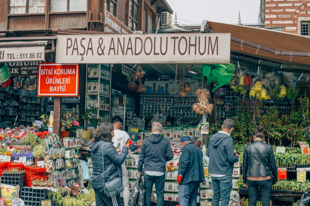 people standing in front of a market