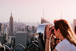 a person looking out a window at 30 Rockefeller Plaza