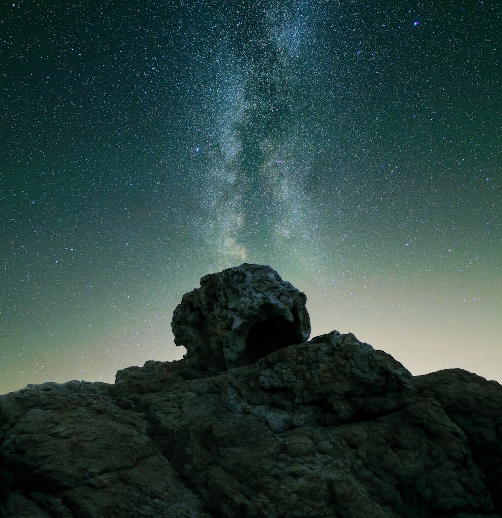 a rocky mountain with stars in the sky