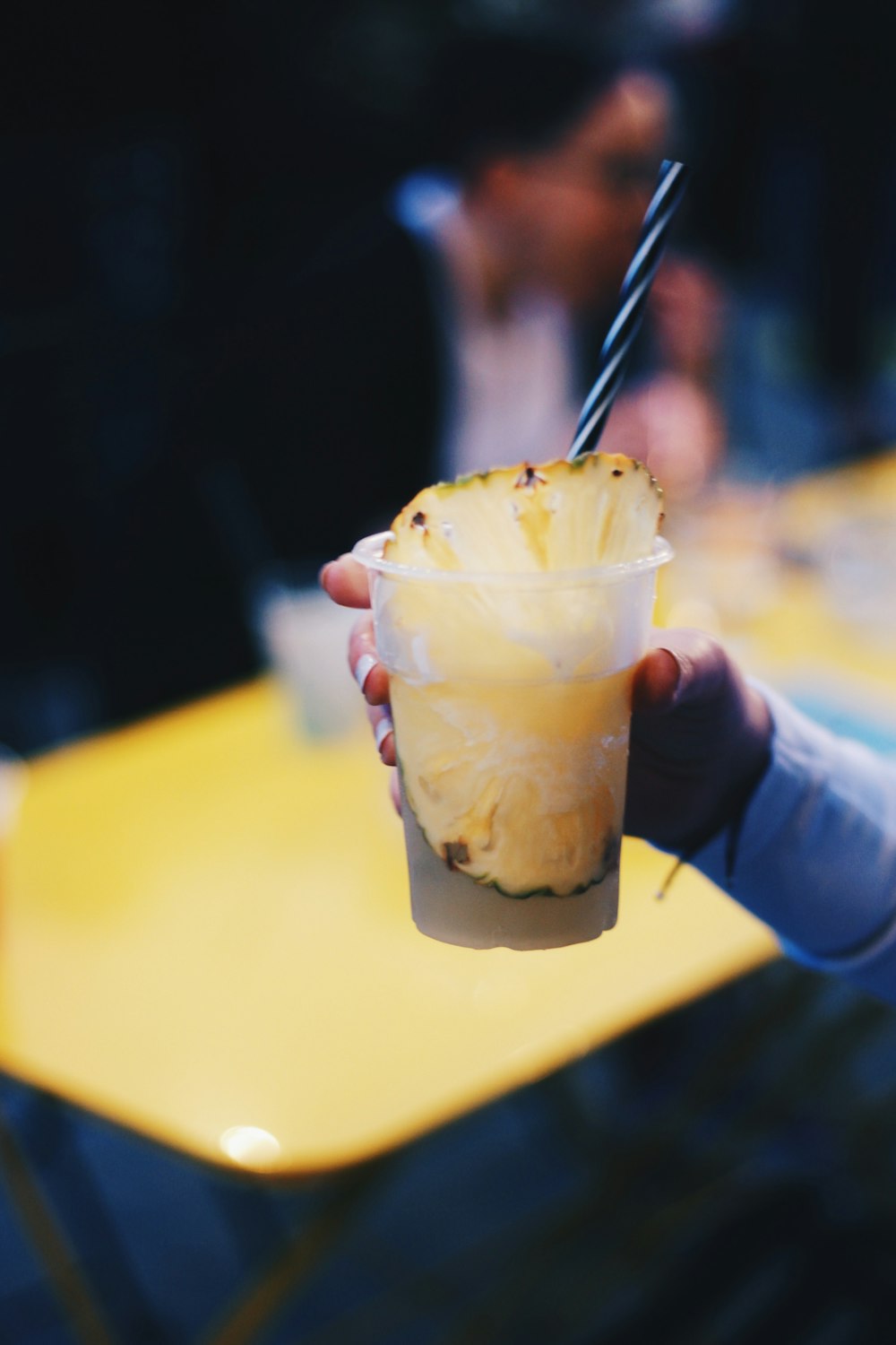 a person holding a cup of ice cream