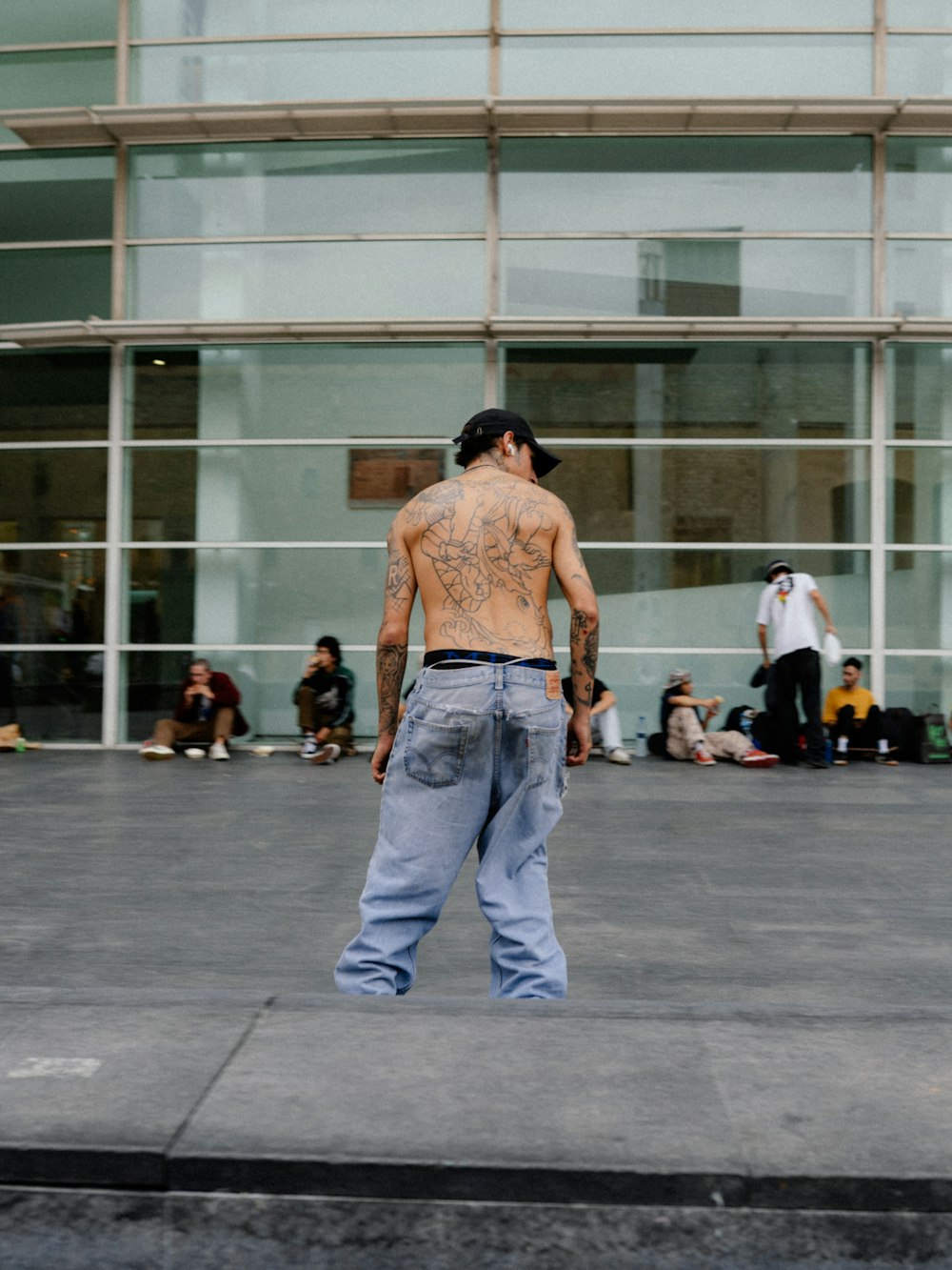 a man wearing a hat and jeans