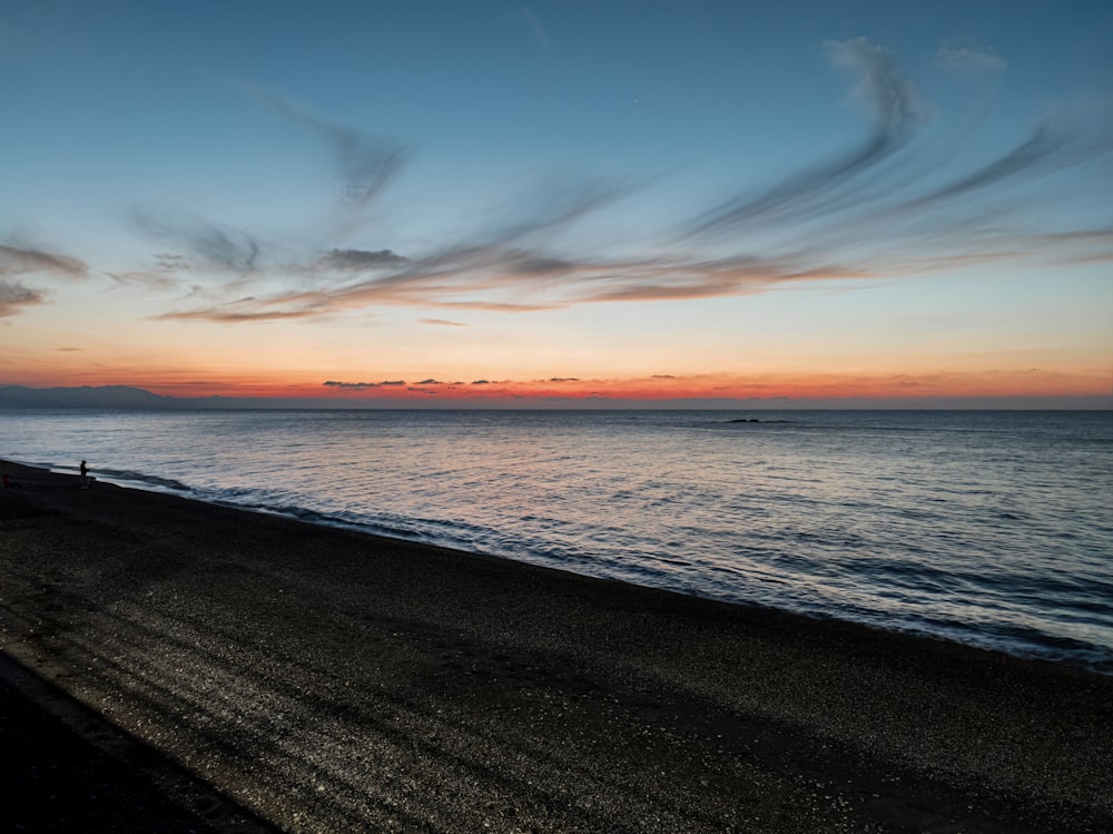 a beach with a sunset