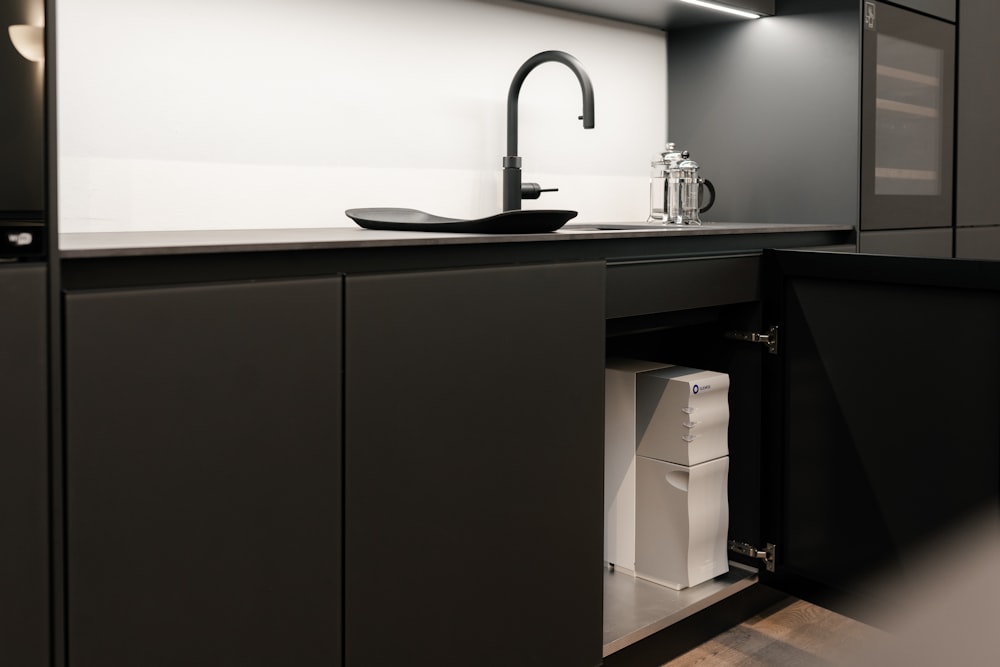 a kitchen with black cabinets