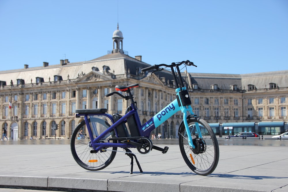 a bicycle parked on a sidewalk