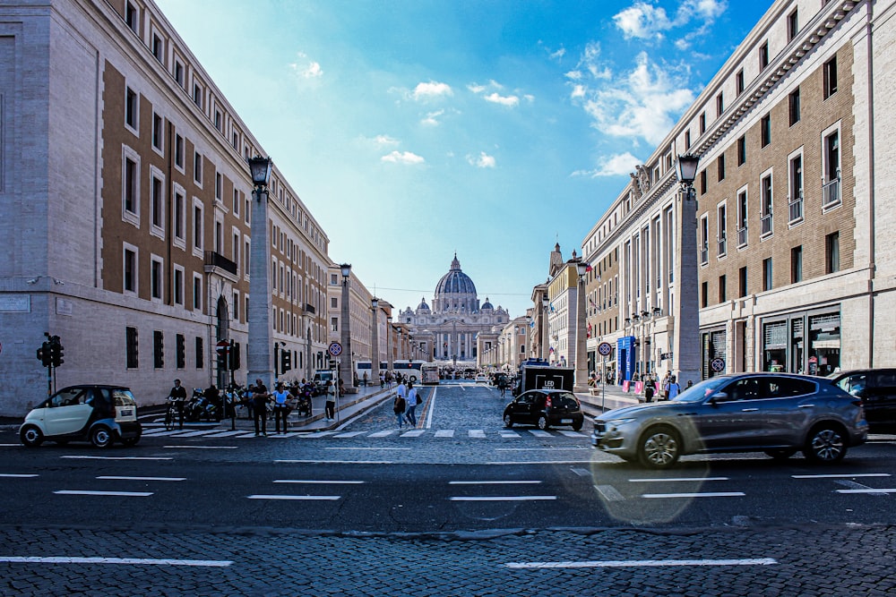 a street with cars and people on it and buildings around it