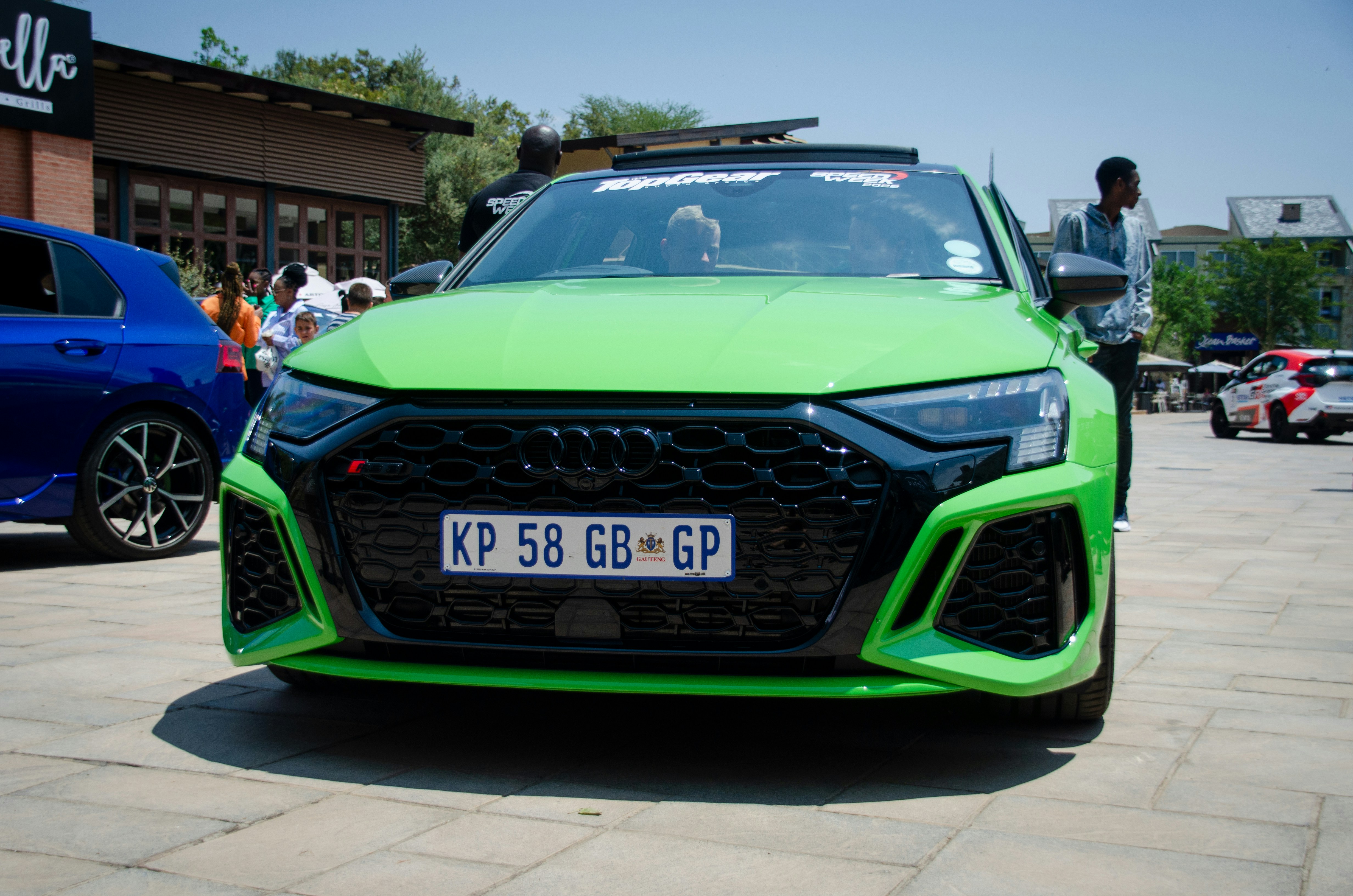 a green car parked on a street